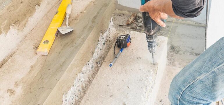 Concrete injections and repair work in progress, with specialized materials being injected into cracks and damaged areas to restore the structure’s strength and integrity.